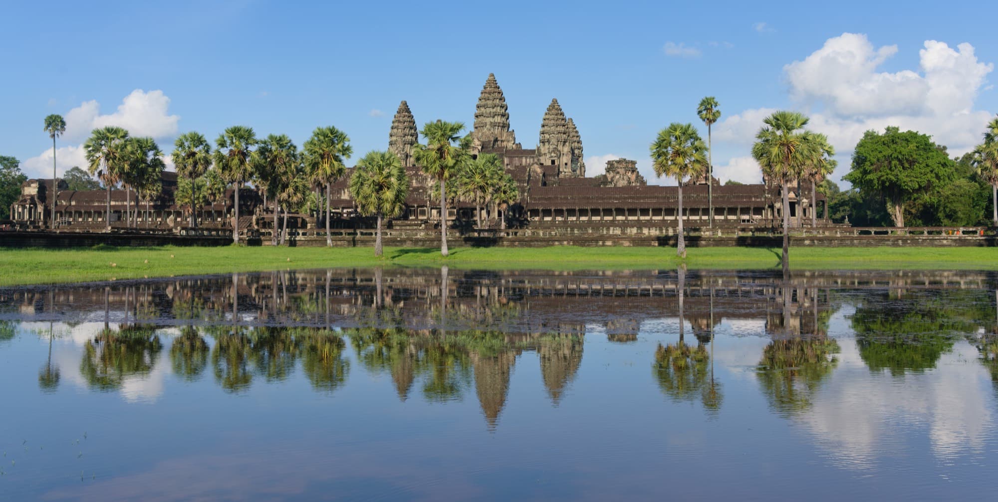 The stone towers of Angkor Wat reflected in the temple moat at dawn, Siem Reap, Cambodia
