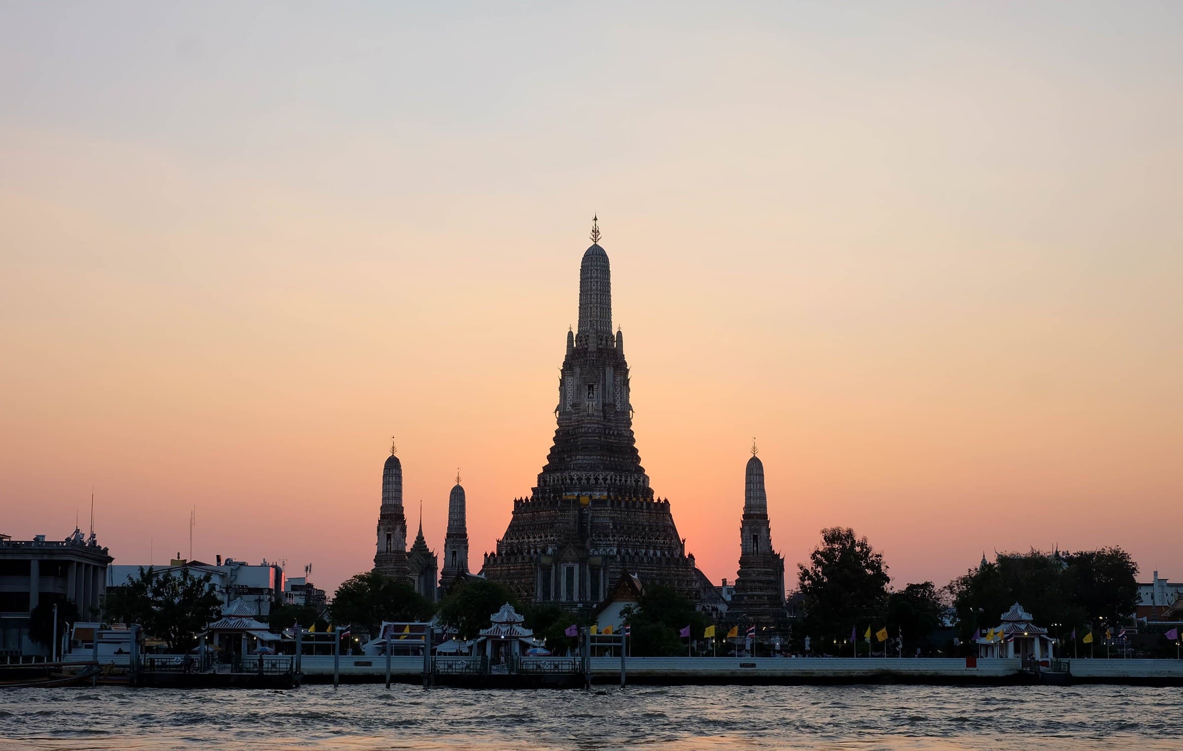 Wat Arun at dusk across the Chao Phraya River, Bangkok, Thailand