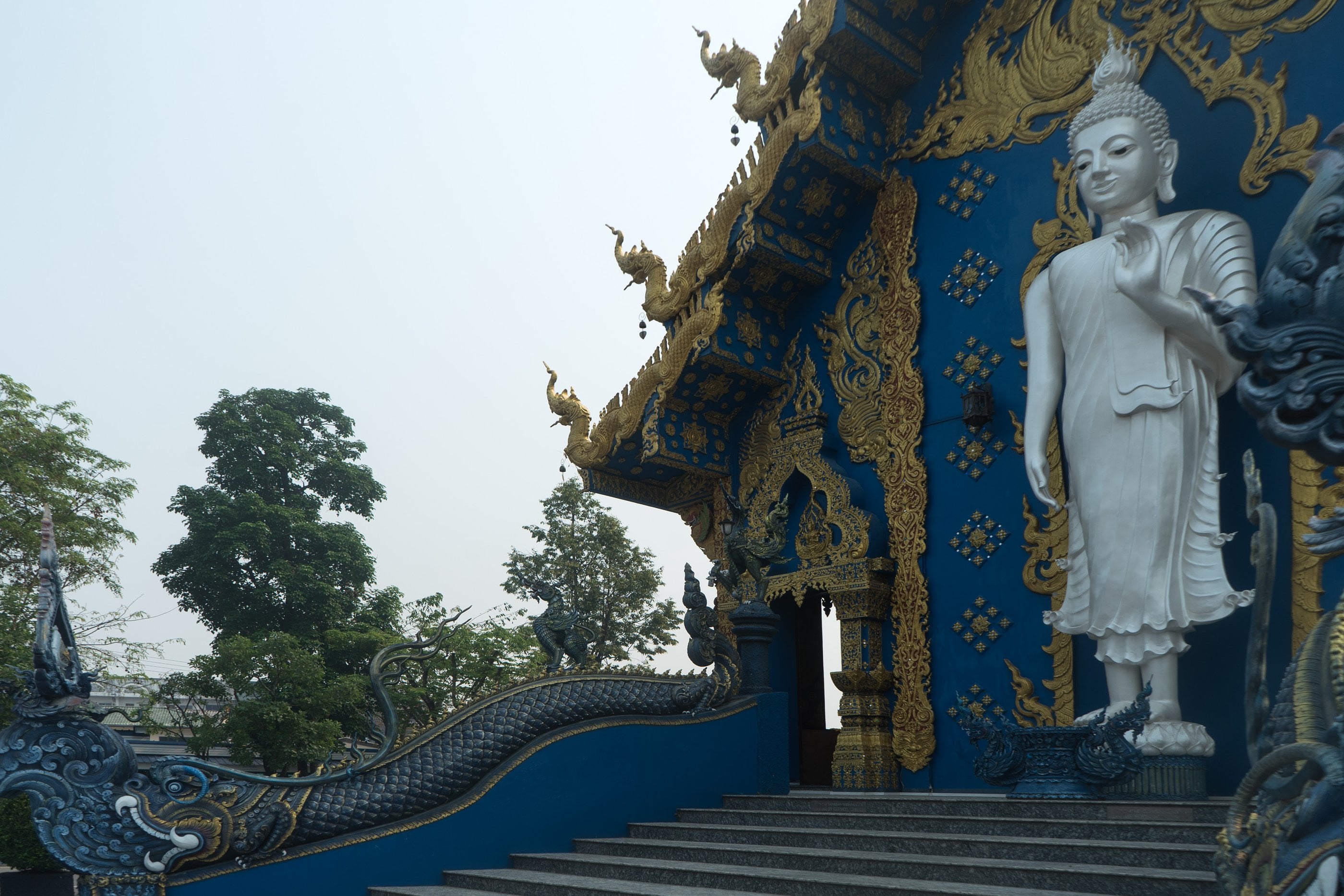 Wat Rong Suea Ten, the Blue Temple, one of Chiang Rai's contemporary art temples in sapphire and gold.