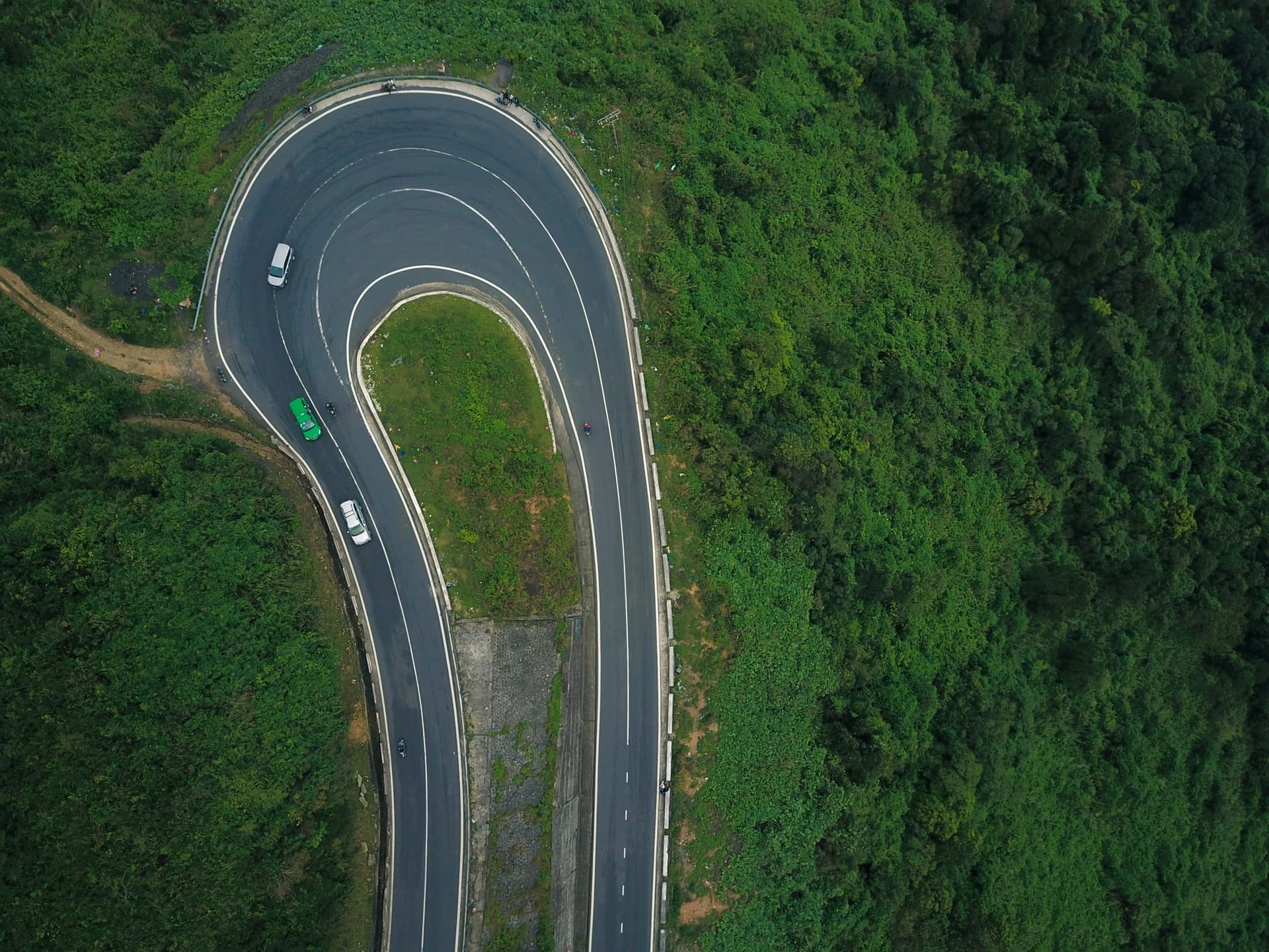 A hairpin bend on a mountain pass in central Vietnam, seen from above, the kind of road a ground partner has to run on the day.