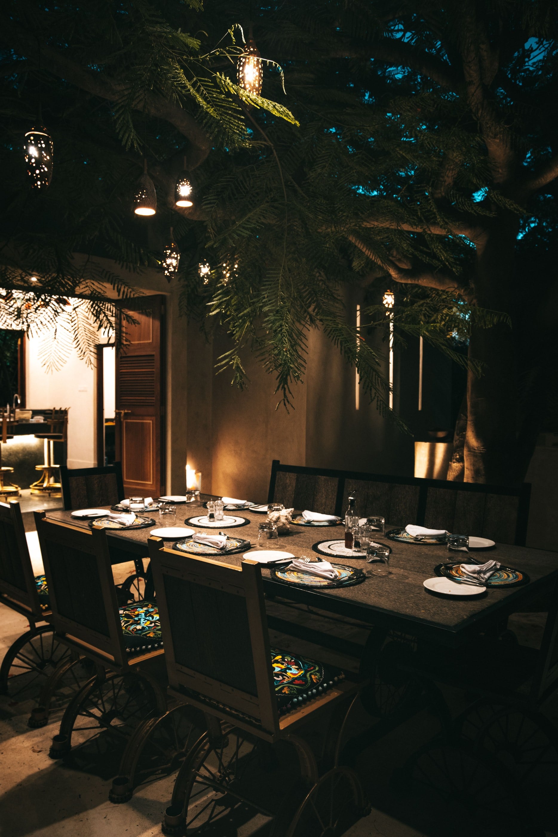 A lantern-lit dinner set outdoors after dark, the kind of evening a private circuit builds around.
