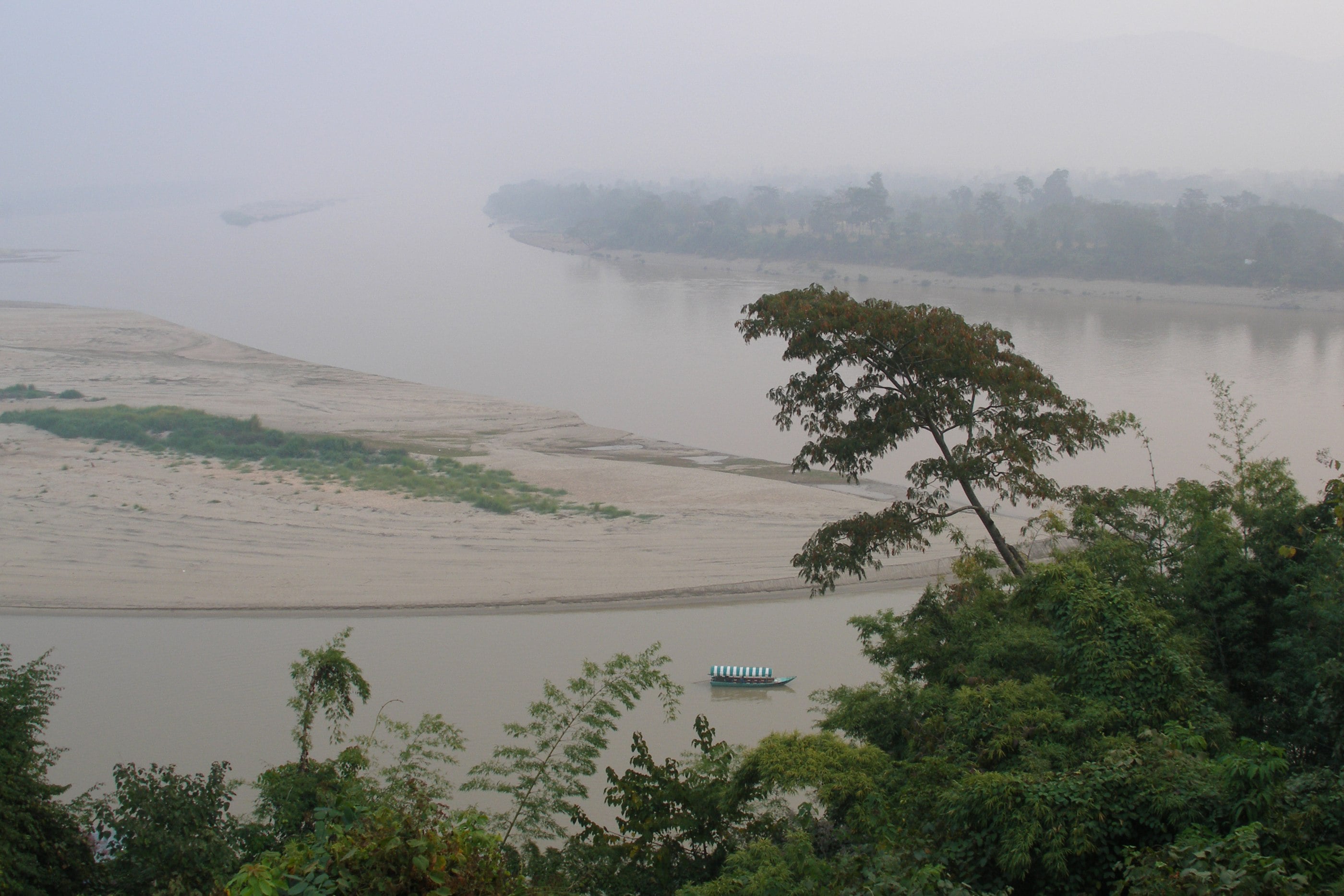 A covered longtail boat on the Mekong at Chiang Saen, the frontier crossing of the Golden Triangle.