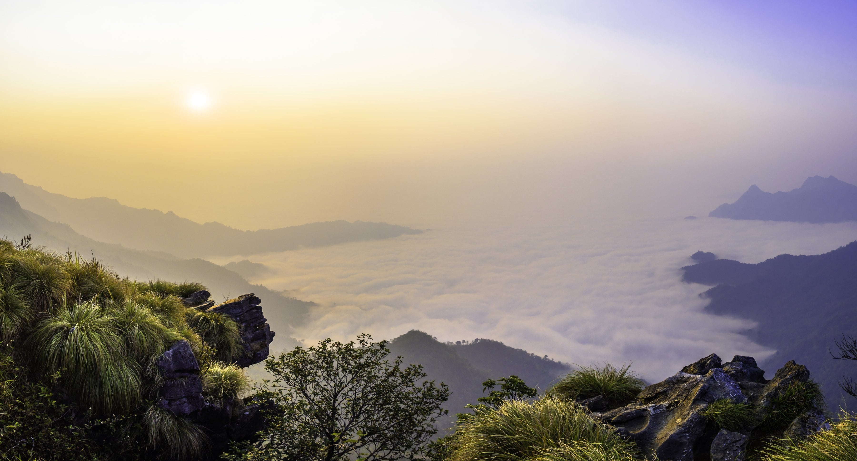Dawn over the sea of mist at Phu Chi Fa, the Lao mountains breaking through the white.