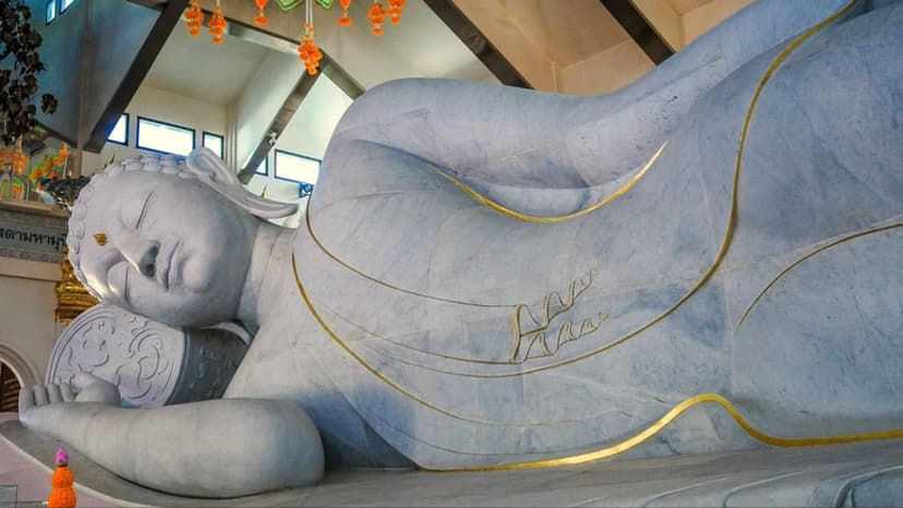 Phra Phuttha Saiyat Lokanat Sasada Maha Muni, the 20-metre reclining Buddha carved from white Italian Carrara marble, its robe traced in gold.