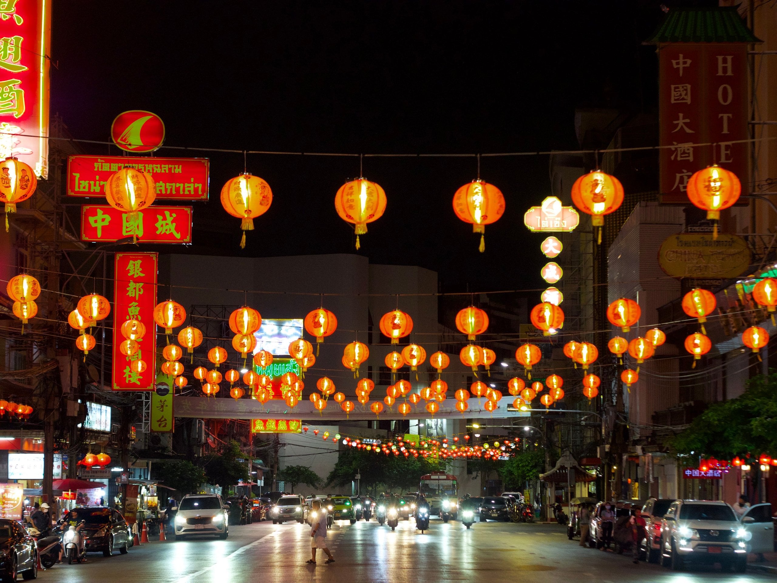 Red lanterns strung above Yaowarat Road in Bangkok's Chinatown at night