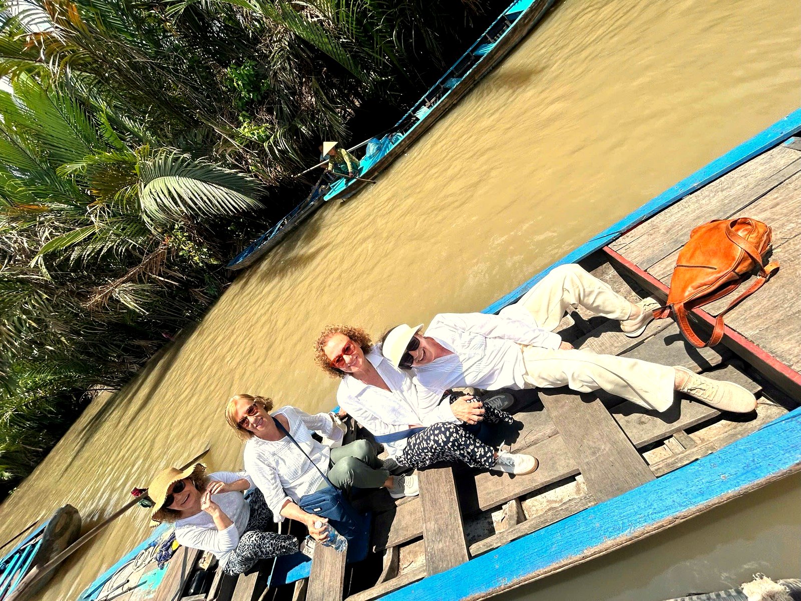 Local boats on a Mekong Delta canal, the heart of a My Tho or Ben Tre day trip.