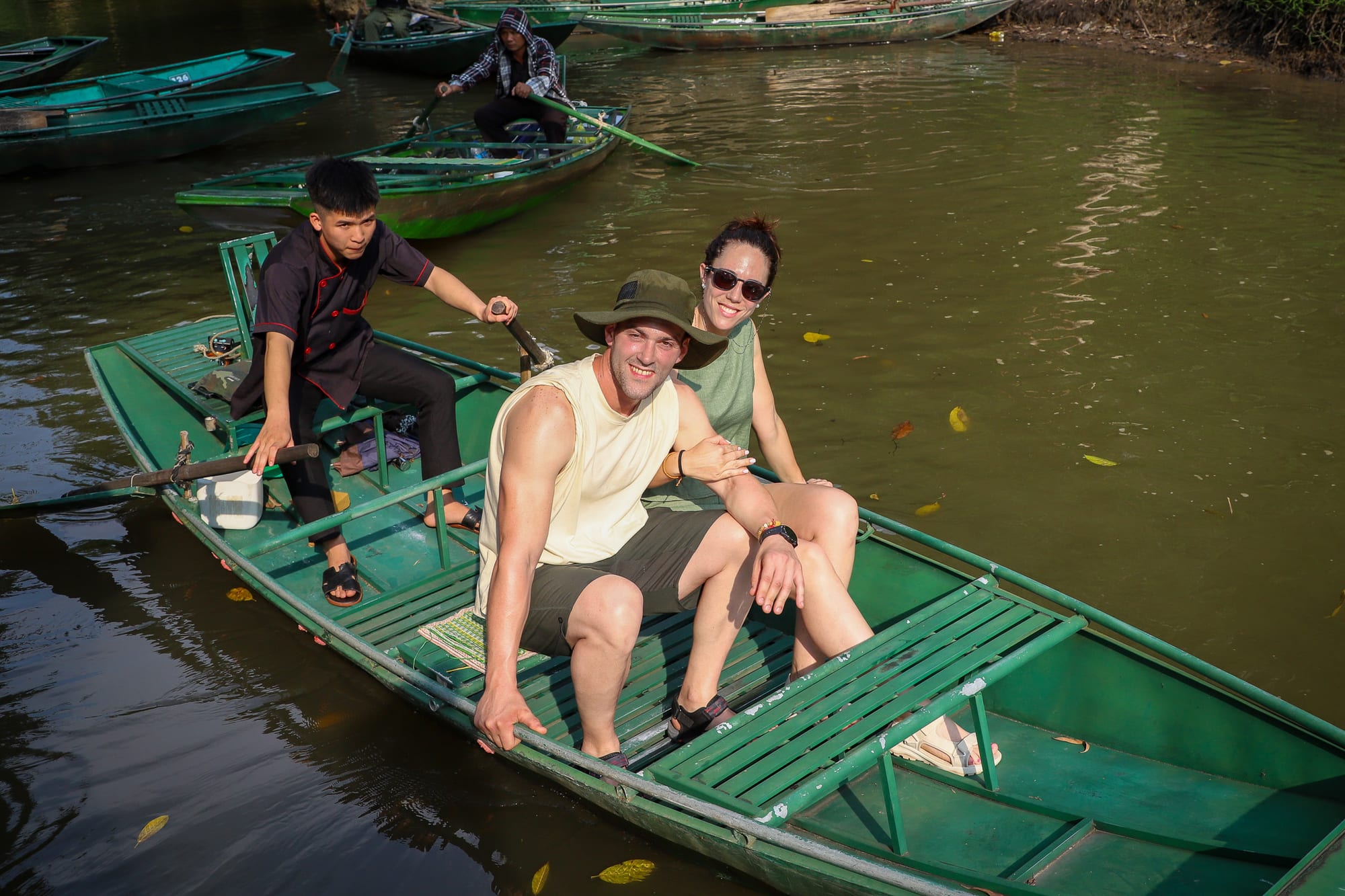 A Pai Dai group on the Tam Coc river through the karst country of Ninh Binh, northern Vietnam.